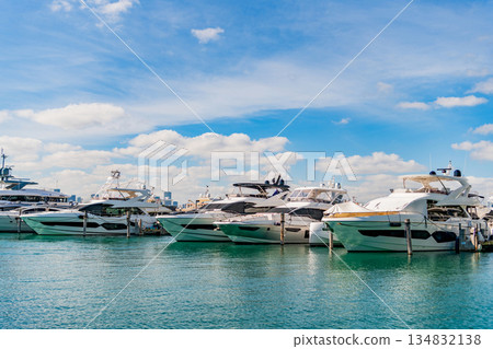 Luxury yacht docked in sea marina. Boating and yachting tourism. Luxurious life. Vacation on summer. Yacht charter. Sea vacation on summer. Luxury boat motor yacht in marina. Coastal marina charm Luxury yacht docked in sea marina. Boating and yachting tourism. Luxurious life. Vacation on summer. Yacht charter. Sea vacation on summer. Luxury boat motor yacht in marina. Coastal marina charm 134832138