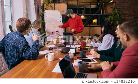 Group of coworkers discussing tasks in modern office. Group of coworkers discussing tasks in modern office. 134832210