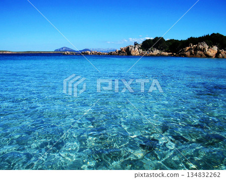 Beautiful panoramic sea view from Beach in Olbia, Sardinia, featuring crystal-clear turquoise water, smooth granite rocks, and soft white sand under a bright Mediterranean sky. This idyllic coastal 134832262