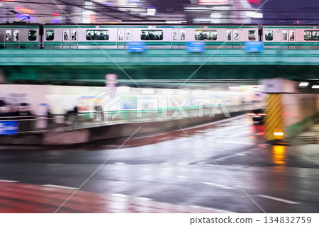 A commuter train running through a rainy city A commuter train running through a rainy city 134832759