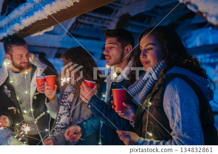 New Year celebration with friends in mountain cabin. 134832861