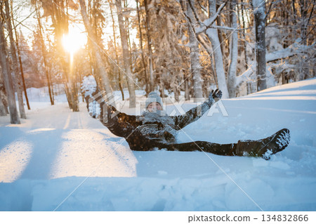 Man jumping into snow, enjoying winter time in nature. 134832866