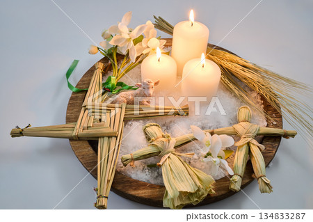 Imbolc altar with brigid's cross, candles, and corn dollies 134833287