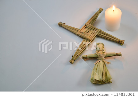St. Brigid's cross, corn dolly, candle celebrating imbolc St. Brigid's cross, corn dolly, candle celebrating imbolc 134833301