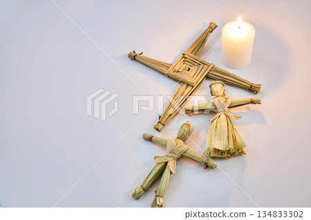 Brigid's cross, corn dolly and candle celebrating imbolc Brigid's cross, corn dolly and candle celebrating imbolc 134833302