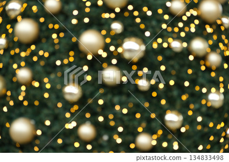Festive Christmas Bokeh Background with Golden Ornaments and Sparkling Lights. Festive Christmas Bokeh Background with Golden Ornaments and Sparkling Lights. 134833498