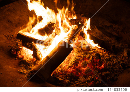 Close-up of Logs Burning with Intense Yellow and Orange Flames. Close-up of Logs Burning with Intense Yellow and Orange Flames. 134833506