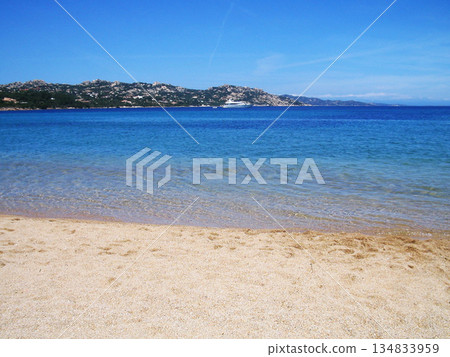 Beautiful beach view in Olbia, Sardinia, featuring crystal-clear turquoise water, white sandy shore, and the pristine Mediterranean coastline. Sunlit sea, gentle waves, and a relaxing coastal Beautiful beach view in Olbia, Sardinia, featuring crystal-clear turquoise water, white sandy shore, and the pristine Mediterranean coastline. Sunlit sea, gentle waves, and a relaxing coastal 134833959