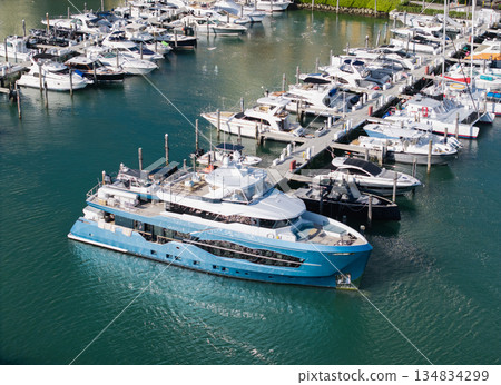 Yacht club and marina. Luxury marina with private yacht and boat. Docked yacht boat in harbor. Luxury summer vacation in sea. Private boat top view. Marina with luxury sea boat 134834299