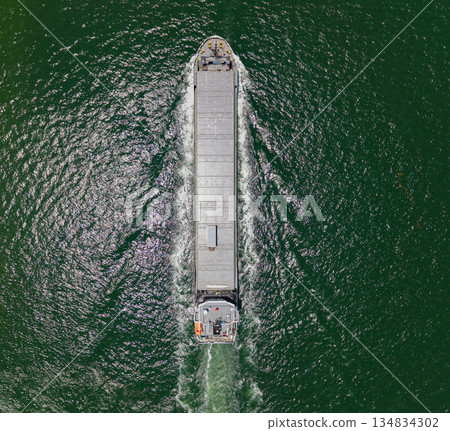 Container ship. Shipping logistics. Commercial shipping. Cargo ship in sea, aerial view. Freight container loaded on cargo vessel. Aerial cargo ship with container. Cargo business. Ship departure 134834302