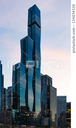 Architecture of modern office building. Night city skyscraper. Business skyscraper building. Illuminated building in business area. Glass skyscraper at night. Night cityscape. City architecture Architecture of modern office building. Night city skyscraper. Business skyscraper building. Illuminated building in business area. Glass skyscraper at night. Night cityscape. City architecture 134834326
