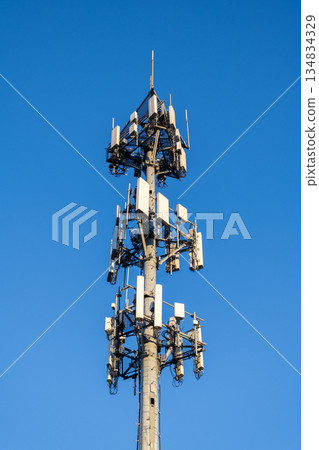 Cell phone tower. Wireless communication. Mobile service. Modern telecommunications infrastructure. Antenna technology of cellular base station. Cell site tower. Broadcasting tower station 134834329