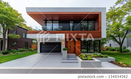 Modern two-story house with wood and white facade, showcasing sleek design and contemporary architecture 134834562