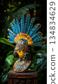 Intricate carved parrot bust adorned with vibrant turquoise and gold headdress, a striking display of ancient artistry 134834629