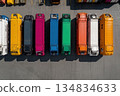 A row of brightly colored delivery trucks parked in a lot, viewed from above 134834633