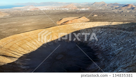 A volcano crater, beautiful volcanic mountains of Lanzarote, Canary islands at sunset. A volcano crater, beautiful volcanic mountains of Lanzarote, Canary islands at sunset. 134835381