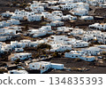 White buildings, town among volcanic black mountains and lava formations in Lanzarote, Canary Islands. 134835393