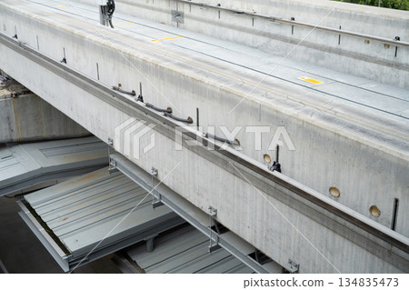 Elevated railway track construction. Concrete beams and steel support structure with prefabricated platform. Modern urban mass transit infrastructure development project. Urban public transportation. 134835473