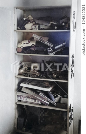A vintage photograph of a collection of boys' toys. Cars, tanks, and other items are displayed on shelves. Photo from 1972. 134835521