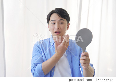 Man looking in the mirror, 20s, beauty 134835648