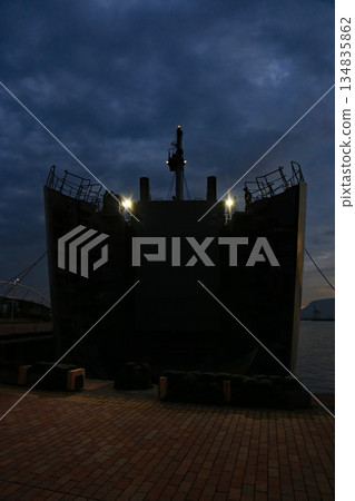 A transport ship opening and closing its bow ramp before dawn A transport ship opening and closing its bow ramp before dawn 134835862