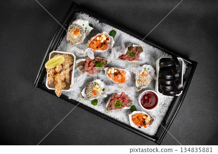 Healthy food. Seafood and toast in a frying pan on a wooden board on a black background. Healthy food. Seafood and toast in a frying pan on a wooden board on a black background. 134835881