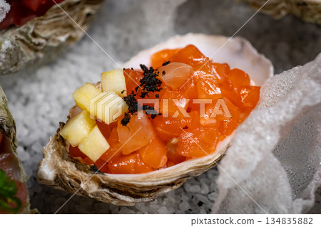 Healthy food. Seafood and toast in a frying pan on a wooden board on a black background. 134835882