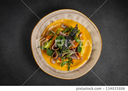 Pumpkin salad with dried duck, cherry tomatoes and pumpkin seeds. Close-up, selective focus Pumpkin salad with dried duck, cherry tomatoes and pumpkin seeds. Close-up, selective focus 134835886