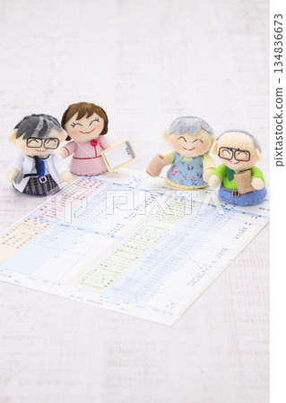 Doctor, nurse, grandma and grandpa dolls and medical examination result form 134836673