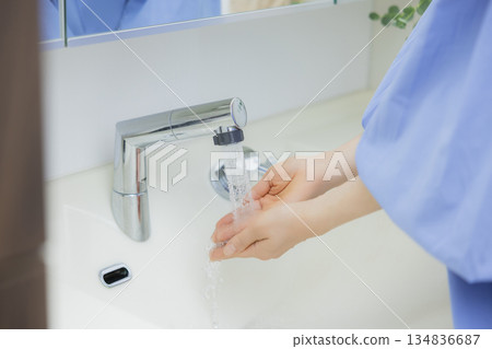 Woman washing hands Woman washing hands 134836687
