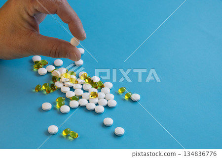 Hand holding assorted vitamin pills Hand holding assorted vitamin pills 134836776