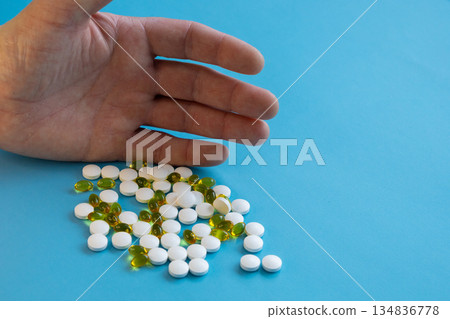 Hand holding assorted vitamin pills Hand holding assorted vitamin pills 134836778