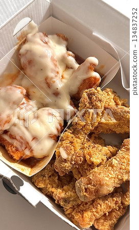 Crispy Korean fried chicken, perfectly glazed with a sweet and spicy sauce. Ideal for food photography and menus, showcasing the irresistible crunch and flavor of this beloved dish. 134837252