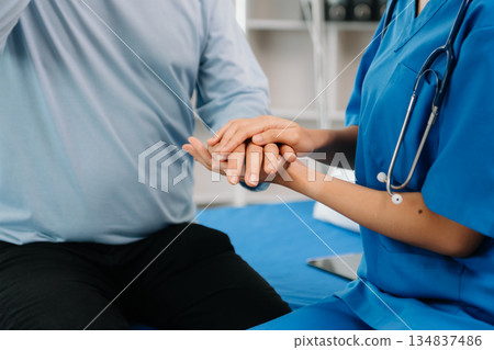 Asian female hands touching senior male hand Helping hands take care of the elderly concept 134837486