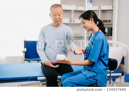 Asian female hands touching senior male hand Helping hands take care of the elderly concept Asian female hands touching senior male hand Helping hands take care of the elderly concept 134837490