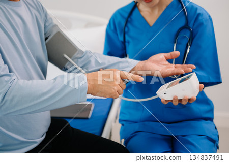 Asian female hands touching senior male hand Helping hands take care of the elderly concept Asian female hands touching senior male hand Helping hands take care of the elderly concept 134837491