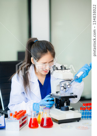Female biotechnologist testing new chemical substances in a laboratory. Female biotechnologist testing new chemical substances in a laboratory. 134838022