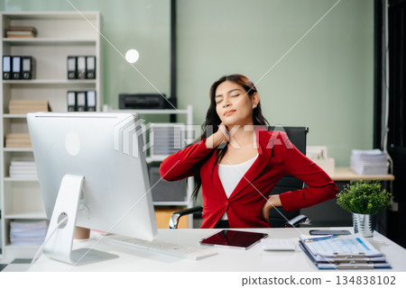 Overworked young Asian businesswoman office worker suffering from neck pain after had a long day Overworked young Asian businesswoman office worker suffering from neck pain after had a long day 134838102