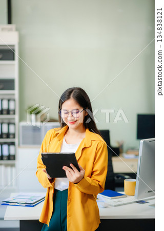 Young businesswoman standing in the boardroom of a modern office. 134838121
