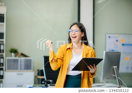 Young businesswoman standing in the boardroom of a modern office. 134838122