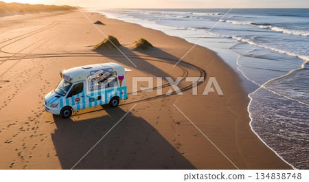 Ice Cream Van On Sandy Beach At Sunset With Ocean Waves And Tire Tracks 134838748