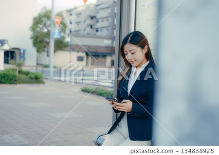 Japanese female university student thinking about job hunting at a bus stop 134838928
