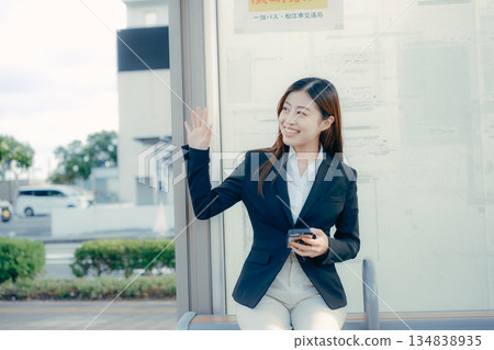Japanese female university student thinking about job hunting at a bus stop 134838935