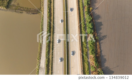 Aerial view of street in Bangkok Thailand with cars and countryside Aerial view of street in Bangkok Thailand with cars and countryside 134839012