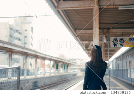 A Japanese female university student operating a smartphone on the station platform A Japanese female university student operating a smartphone on the station platform 134839125