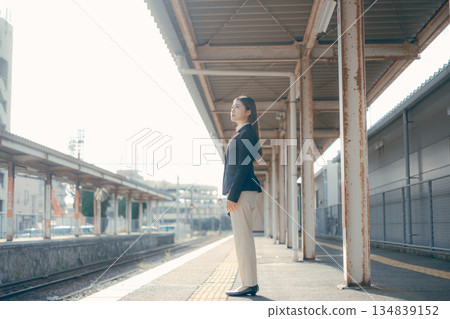 Japanese female university student standing on the station platform Japanese female university student standing on the station platform 134839152