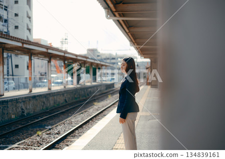 Japanese female university student standing on the station platform Japanese female university student standing on the station platform 134839161