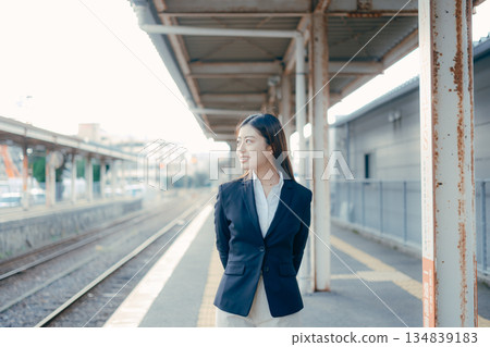 Japanese female university student standing on the station platform Japanese female university student standing on the station platform 134839183