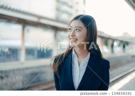 Japanese female university student standing on the station platform 134839191