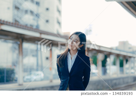 Japanese female university student standing on the station platform Japanese female university student standing on the station platform 134839193